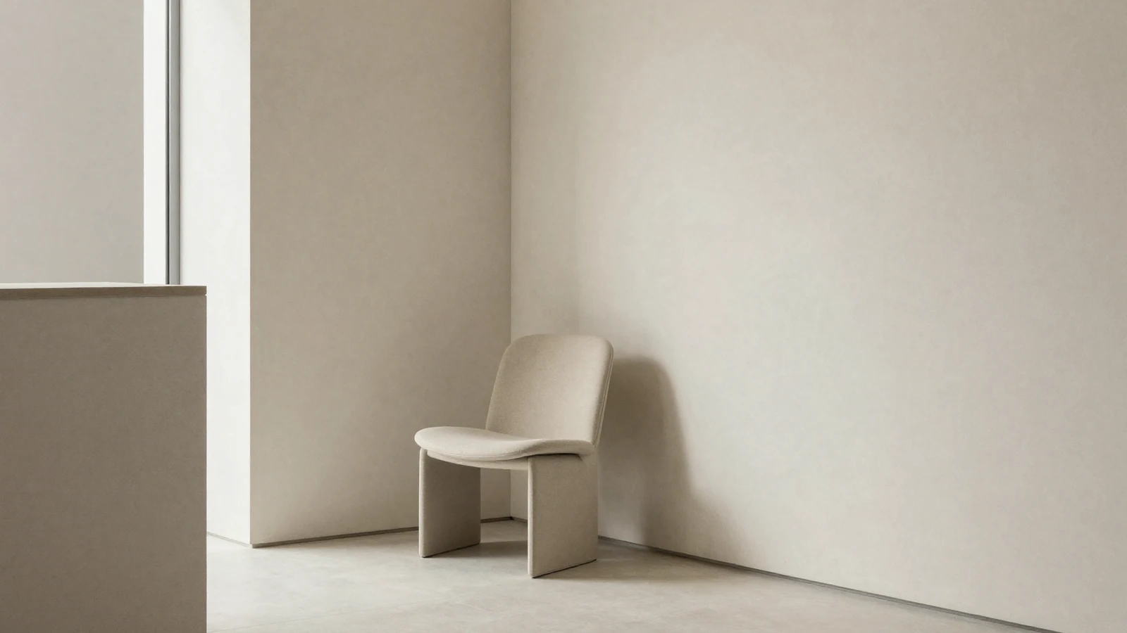 Rincón de espera minimalista con luz natural lateral, ambiente de primera visita.